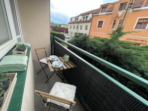 a balcony with a table and chairs on a balcony at Beroun apartments in Beroun