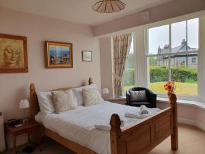 a bedroom with a bed and a large window at Crown Hill, Grange over Sands in Grange Over Sands