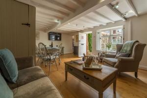 a living room with a couch and a table at Sextons Yard Cottage in Docking
