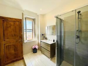a bathroom with a shower and a sink and a glass shower stall at Smeralda Sea View - Luxury Apartment in Olbia +29 photos