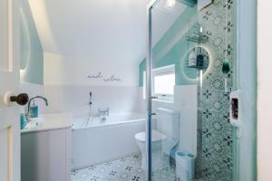 a bathroom with a shower and a toilet and a sink at Pyecroft Cottage in Chester +21 photos