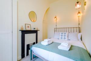 a bedroom with a bed with towels on it at Pyecroft Cottage in Chester