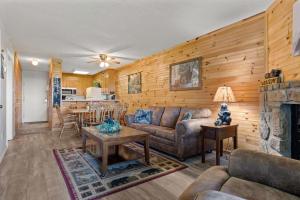 a living room with a couch and a fireplace at Bear Cub Retreat in Gatlinburg