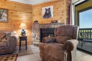a living room with a fireplace and two chairs at Ski View Mountain Resort 305, 2 Bedrooms, Mountain Views, WiFi, Sleeps 6 in Gatlinburg