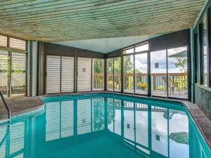 a swimming pool in a house with a large window at Bear Cub Retreat in Gatlinburg