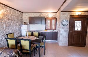 a kitchen with a table and chairs in a room at Twin Castles Maisonettes by RentalsPro - Kriopigi Halkidiki in Kriopigi