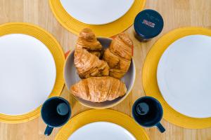 a table topped with a plate of croissants and cups of coffee at Talbot House in Chester