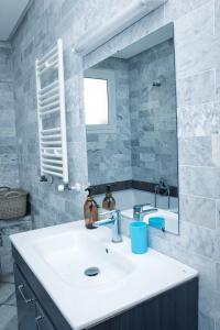 a bathroom with a white sink and a mirror at The Pearl Apartment Hammam Sousse WIFI in Sousse +24 photos