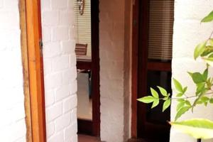 a door leading into a room with a mirror at Carol Close Upstairs - A spacious apartment with a view in Durbanville