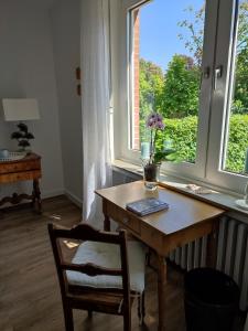a table and a chair in front of a window at Van´s Zimmerglück in Borken
