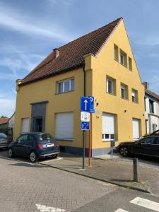 a yellow house with cars parked in front of it at Orange Dolce in Zaventem