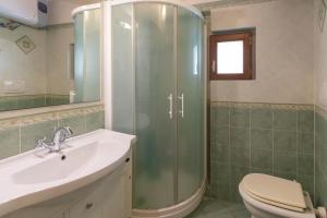 a bathroom with a shower and a sink and a toilet at Appartamento La Scaletta del Chiasso in Capoliveri +16 photos