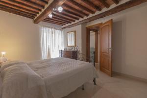 a bedroom with a large bed and a wooden ceiling at Appartamento La Scaletta del Chiasso in Capoliveri