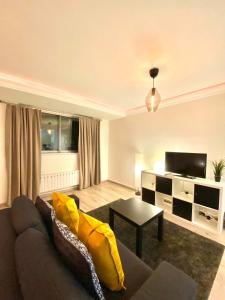 a living room with a couch and a tv at LUXURY Apt - Balcony- Kensington-24 7 security in London