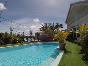 聖丹尼斯的住宿－La Villa Vie d'Hôte，一座房子旁的院子内的游泳池