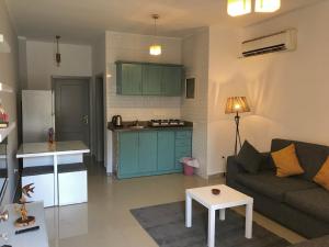 a living room with a couch and a kitchen at Sunny Dahab Resort Family Deluxe in Dahab