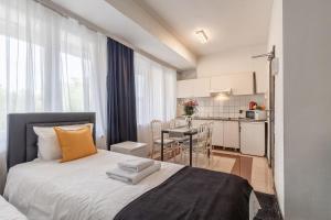 a small bedroom with a bed and a kitchen at Albert gare du Midi , 29 in Brussels