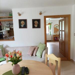 a living room with a couch and a table at Old house in Forest in Křemže