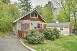 a small house with a porch and a yard at Cozy Tuftonboro Home with Deck - Walk to Beaches! in Center Tuftonboro