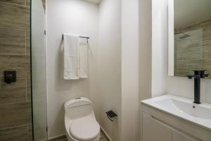 a bathroom with a toilet and a sink at First Class Hotel in Medellín