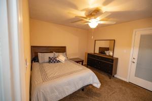 a bedroom with a bed and a ceiling fan at Southern Sanctuary in Tallahassee