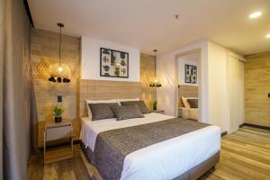 a bedroom with a large bed in a room at First Class Hotel in Medellín