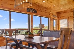 a dining room with a table and chairs in a cabin at Dolly Valley View in Sevierville