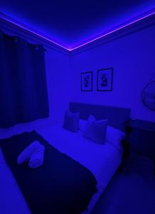 ロンドンにあるModern Double Room in Kensington Central Londonのベッドルーム1室(青い照明付きのベッド1台付)