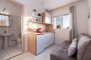 a kitchen with a couch and a sink and a toilet at Orion in Neos Marmaras
