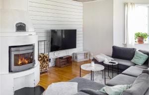 a living room with a couch and a fireplace at Beautiful Home In Gvle With Sauna in Gävle