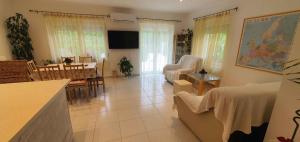 a living room with a couch and a dining room at Holiday home in Keszthely - Balaton 39648 in Keszthely