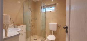 a bathroom with a shower and a toilet and a sink at Holiday home in Keszthely - Balaton 39648 in Keszthely +41 photos