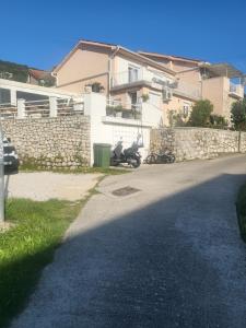 a motorcycle parked in front of a house at Apartment Grabar in Cres