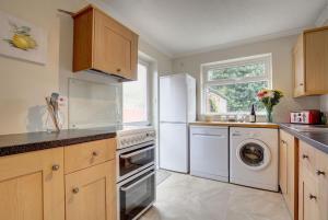 a kitchen with a white refrigerator and a dishwasher at Dolphin in Burnham Market