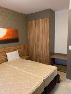 um quarto com uma cama e um quadro na parede em Flat dentro Parque do Peão de Barretos em Barretos
