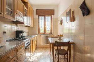 a kitchen with a table and a stove top oven at Il Cerro - Sarnico in Sarnico