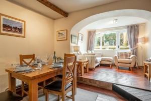 a dining room with a table and a living room at Harbour View Cottage in Wells next the Sea
