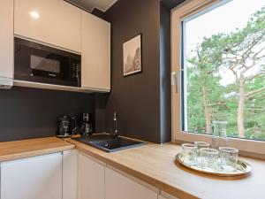 a kitchen with a counter with glasses on it at VacationClub – Sosnowa 4 Apartament 5 in Mielno