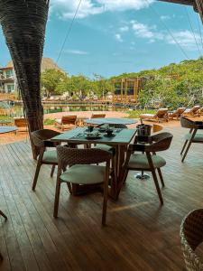 a table and chairs on top of a deck at Hotel Shibari - Restaurant & Cenote Club in Tulum