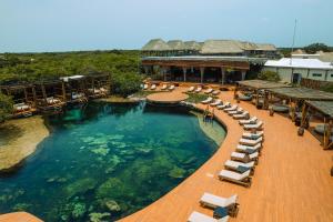 an outdoor pool with lounge chairs and a resort at Hotel Shibari - Restaurant & Cenote Club in Tulum