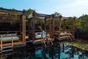 a pavilion on the water at a resort at Hotel Shibari - Restaurant & Cenote Club in Tulum