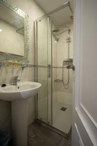 a bathroom with a sink and a shower at Hotel Marín in Marín