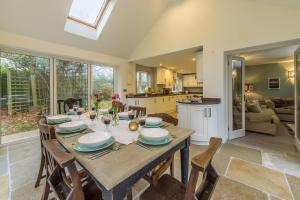 uma cozinha e sala de jantar com mesa e cadeiras em Owl Cottage Woodside em Burnham Market