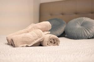 a towel laying on top of a bed at Stylish City Centre Studio - Grand Central House in Gibraltar