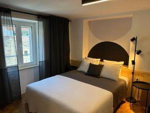 a bedroom with a large bed and a window at Centrum Bol Apartment - One Minute from the Sea in Bol