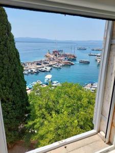 a view of a harbor with boats in the water at Centrum Bol Apartment - One Minute from the Sea in Bol +16 photos