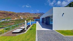 a house with a balcony with a view of the mountains at Villa Blue Horizon by LovelyStay in Tábua