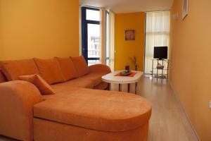 a living room with a couch and a table at Spa Villa Crystal in Hisarya