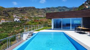 a swimming pool on the balcony of a house at Villa Blue Horizon by LovelyStay in Tábua