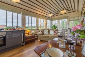 a kitchen and living room with windows and a couch at The Signal Box in Melton Constable +14 photos